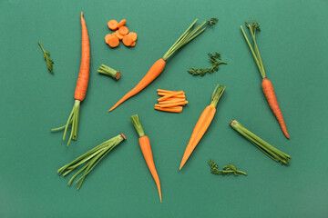 Sliced, peeled and fresh carrots on green background