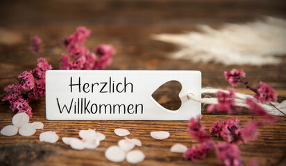 Natural Background With Label With Herzlich Willkommen
