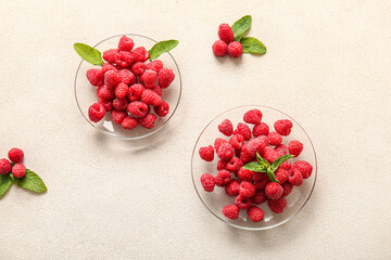 Glass plates with fresh raspberries and mint on white background