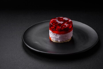 Delicious fresh sweet cheesecake cake with berries and red color jelly