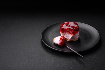 Delicious fresh sweet cheesecake cake with berries and red color jelly