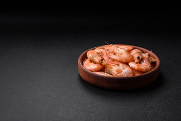 Delicious fresh boiled tiger prawns with salt and spices on a ceramic plate