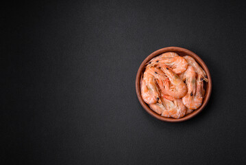 Obraz na płótnie Canvas Delicious fresh boiled tiger prawns with salt and spices on a ceramic plate