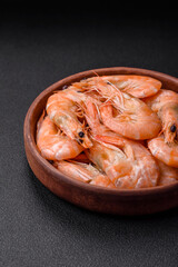 Delicious fresh boiled tiger prawns with salt and spices on a ceramic plate