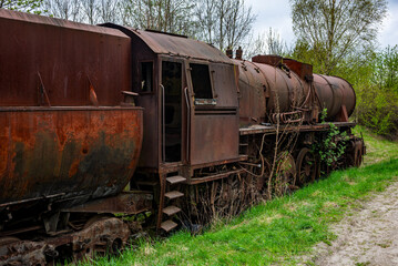 Old rusted steam locomotive abandoned at train cemetery