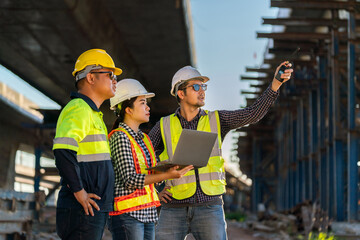 A Professional team of engineers, architects, inspecting and working outside on expressway...