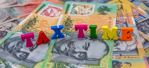 'Tax Time' concept with australian dollars and clock on it close up