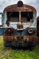 Old rusty electric train abandoned on unused siding