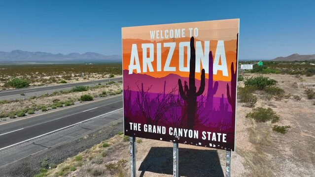 Arizona, The Grand Canyon State. Aerial rising shot of state sign along interstate highway in the desert of AZ.