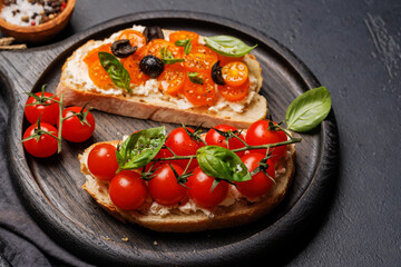 Sandwich set of bruschetta with juicy tomatoes, cheese and prosciutto