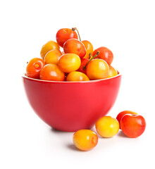 Bowl with sweet yellow cherries on white background