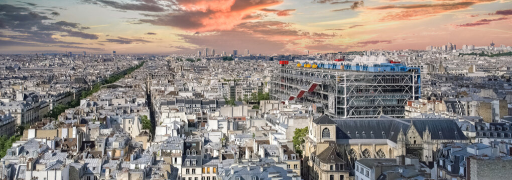 Paris, aerial view of the city, with the Pompidou center, and the Defense in background, sunset
