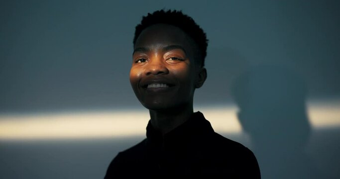 Portrait of a twenty-year-old girl on whose face a stream of warm light falls.