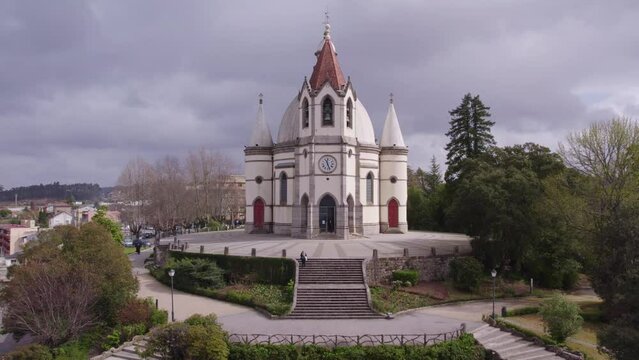 Flying backwards at Jardim do Sameiro at Penafiel during cloudy day, aerial
