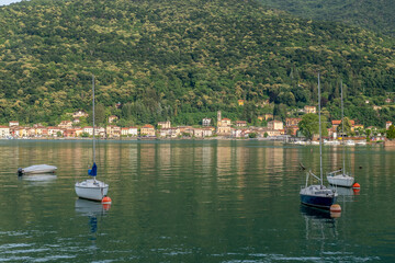 Fototapeta na wymiar Boats anchored on Lake Lugano, with Porto Ceresio in the background, Italy