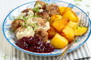 Meatballs with lingonberry sauce, close up.