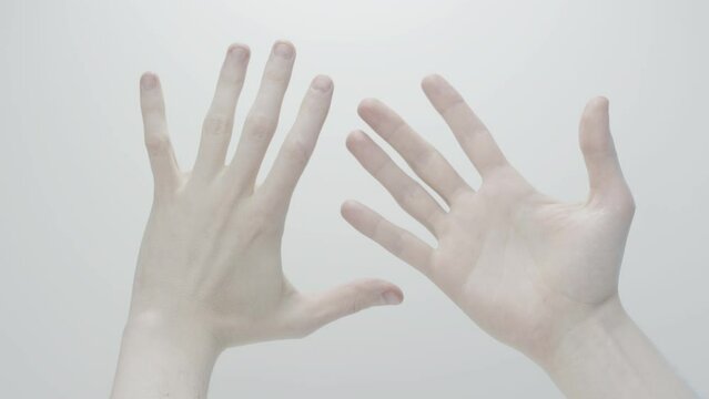 Men's hands close up on white background. Gesticulation. Beautiful hands of a young man. Men's cosmetics.