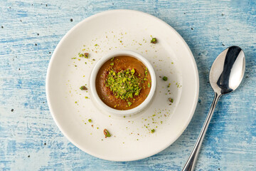 Souffle with pistachio and tahini on a white porcelain plate