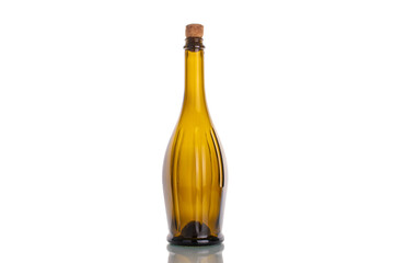 One empty glass bottle with cork, macro, isolated on white background.