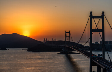 Sunset behind mountain with Tsing Ma bridge in foreground