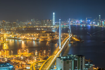 Aerial Night view of the city in Hong Kong with stonecutter bridge