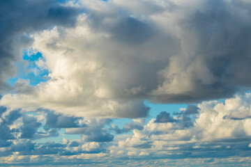 Sky with large cumulus clouds. Gloomy background with a view of the sky.