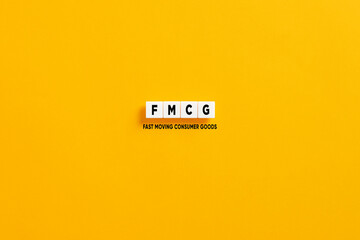 White letter blocks on yellow background with the acronym FMCG fast moving consumer goods.