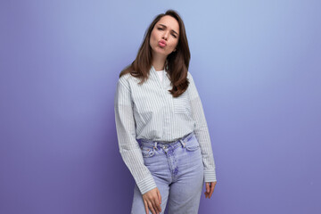 portrait of european model 25s woman with dark hair in casual clothes on studio background with copy space