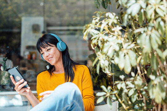 happy mature couple holding hands and walking at beach
