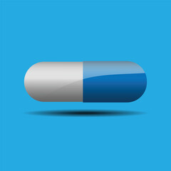 Medical pill capsule on blue background. 