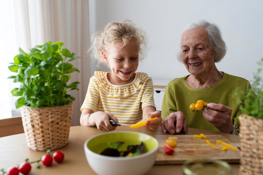 Father and daughters looking at laptop on bed