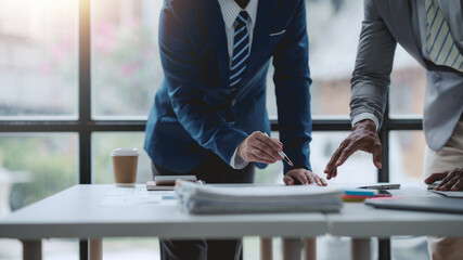 Group of business people working together on new project with planning analytical report at...