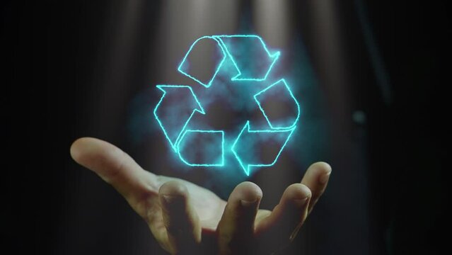 Businessman hand shows glowing blue arrows recycle eco symbol. Technology ecological and save the earth concept. An ecological metaphor for ecological waste management and a sustainable.