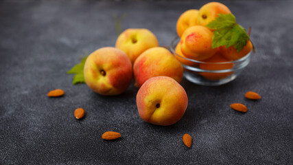 Harvest of peaches for food or juice. fresh organic fruit, vegan food. Large peaches on dark table background, selective focus.