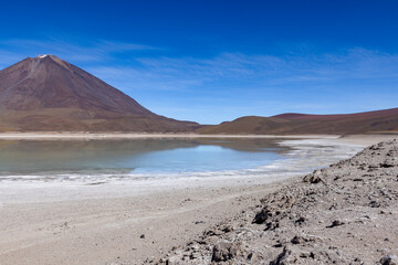 Fototapeta na wymiar Picturesque Laguna Verde with Licancabur Volcano, just one natural sight while traveling the scenic lagoon route through the Bolivian Altiplano