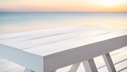 White wood table at an angle at the beach in the evening with copy space