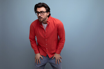 Obraz premium cute caucasian brunette 30s man in red shirt tired