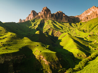 Aerial view of the green mountains and hills at sunset. Aktoprak Pass in North Caucasus, Russia.