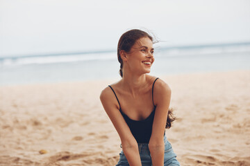 Fototapeta na wymiar nature woman sitting sea travel sand smile vacation fashion beach freedom