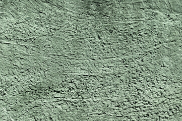 Green stone texture close-up. Rough green stone wall. Natural rock texture