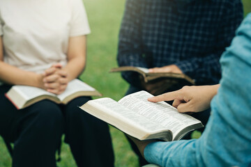 Christian group read and studied the bible at the park and prayed together. sharing the gospel with...