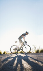 Fototapeta na wymiar Mountain, sports and male cyclist cycling on bicycle training for a race or marathon in nature. Fitness, workout and man athlete riding a bike for cardio exercise on an outdoor off road trail.