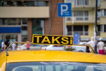 Yellow taxi sign on the street in Turkey.