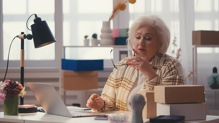 Senior woman entrepreneur displeased with failed order, reading bad news email