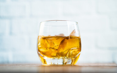 Glass of whiskey with ice on white backgrounds