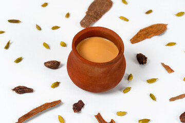 Fresh milk tea or indian karak chai or masala tea in clay cup on white background