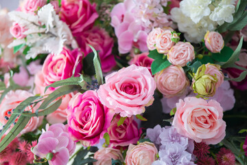 White and pink artificial roses close up. Floral background.