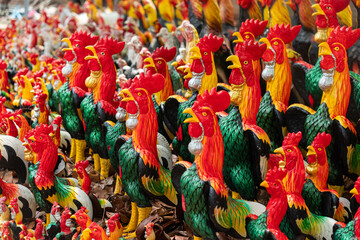 statues of roosters on street in Ayutthaya. Cock Alley. Traditional chicken figurines on the background