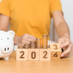 Happy New Year with piggy bank and flipping 2023 change to 2024 block. Resolution, Goals, Plan,...