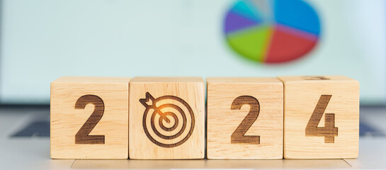 2024 Year block with dartboard icon against computer laptop background. Goal, Target, Resolution,...